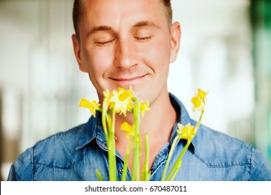 Handsome Man Smelling Flowers