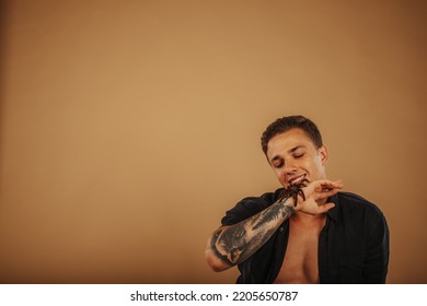 Handsome Man Smiling And Having Fun With His Pet Tarantula At The Studio