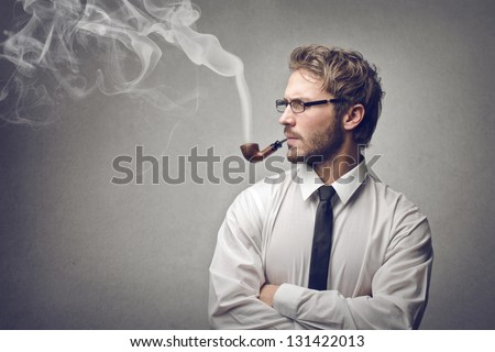 handsome man smokes a pipe