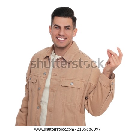 Handsome man snapping fingers on white background