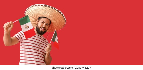 Handsome man in Sombrero and with Mexican flags on red background with space for text