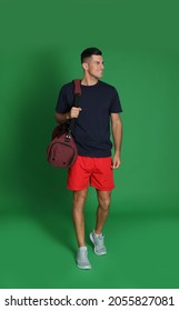 Handsome Man With Sports Bag On Green Background