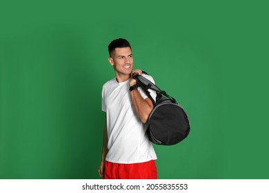 Handsome Man With Sports Bag On Green Background