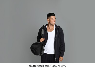 Handsome Man With Sports Bag On Grey Background