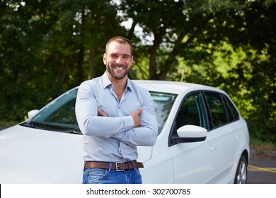 Handsome Man Standing In Front Of Car