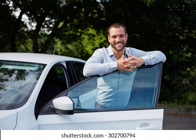 Handsome Man Standing And Leaning On Car Door
