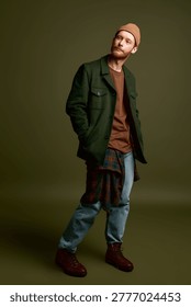 Handsome man stands in a relaxed pose, wearing a trendy ensemble that highlights his style.