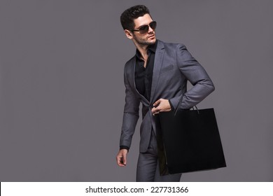 Handsome Man In Suit With Shopping Bag