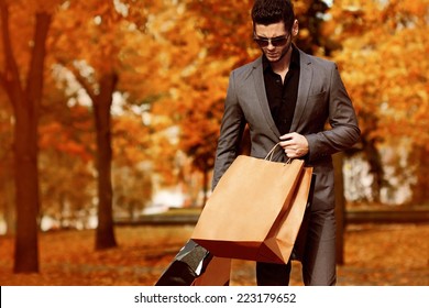 Handsome Man In Suit With Shopping Bags. Autumn.