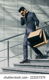 Handsome Man In Suit With Shopping Bags