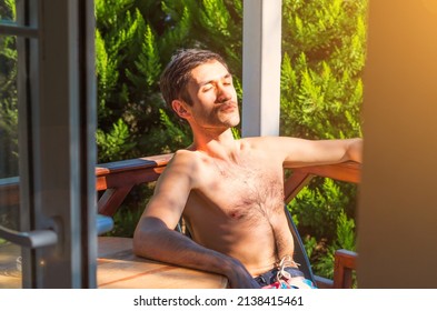 A Handsome Man Sun Bathing In A Beautiful Garden In Summer. Serenity Of Weekend. Peaceful Time Alone On A Sunny Morning.