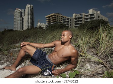 Handsome Man Sunbathing On The Beach