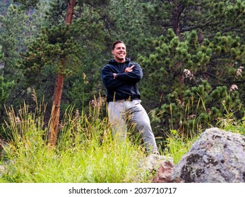 A Handsome Man In Sweat Pants Smiling While Giving The Bird To The Camera. 