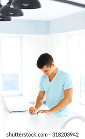 Handsome man taking notes. Concept of start up, creativity, beginnings of entrepreneurship.