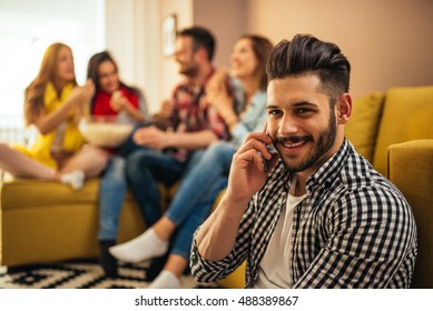 Handsome Man Talking On The Phone On A Home Party.