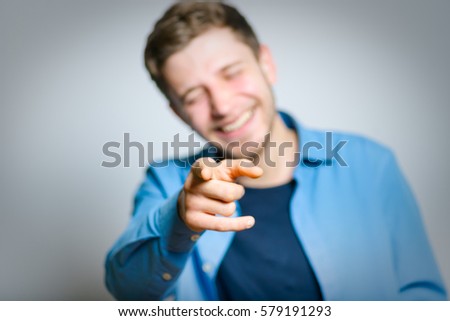 Handsome man taunts, isolated on a gray background