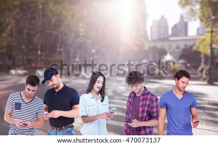 Handsome man text messaging through smart phone against picture of a city