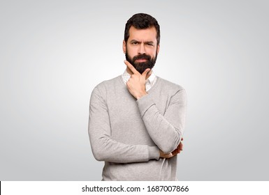Handsome man thinking over isolated grey background