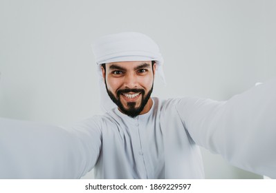 Handsome man with traditional white kandura from uae. Studio portraits with Dubai outfit about fashion and lifestyle