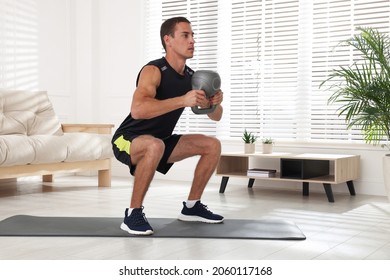 Handsome Man Training With Kettlebell At Home