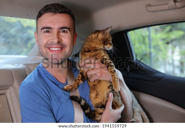 Handsome man traveling with\
his cat