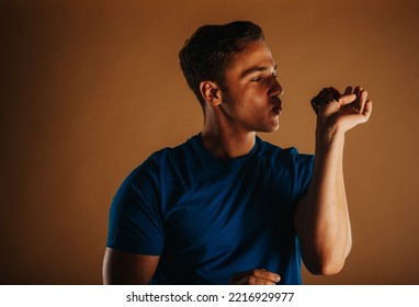 Handsome Man Trying To Kiss His Tarantula While Standing At The Studio