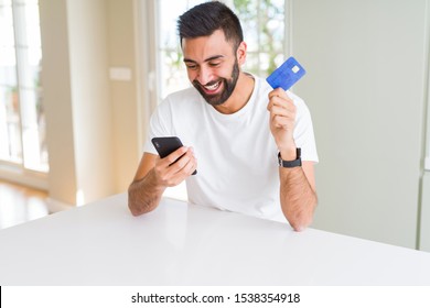 Handsome Man Using Credit Card To Pay Online With Smartphone