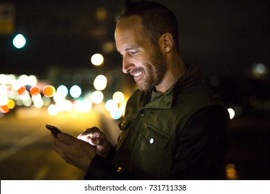 A Handsome Man Using Smart Phone Mobile In The City At Night