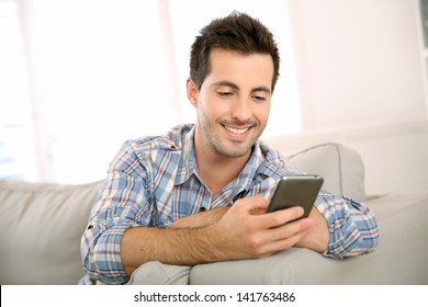 Handsome Man Using Smartphone At Home