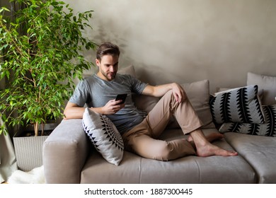 Handsome Man Using Smartphone At Home