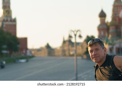 Handsome Man Walking In Moscow City In Hot Summer Day. He Wearing Sunglasses. Famous Red Suare Direction. Tourisic Concept. He Takes A Selfie 