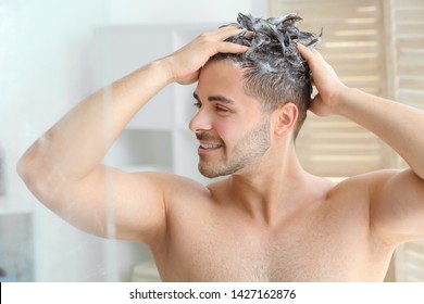 Handsome Man Washing Hair In Bathroom