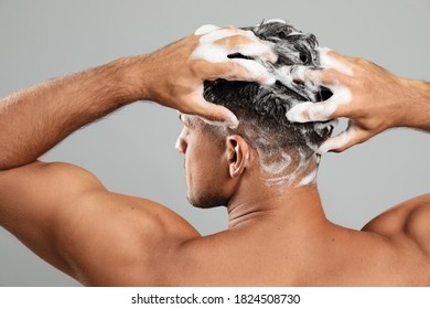 Handsome Man Washing Hair On Grey Background, Back View