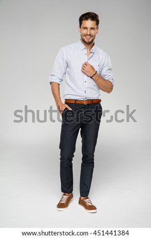 Handsome man wear blue shirt and posing in studio