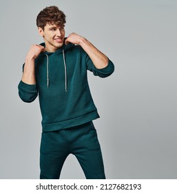 Handsome Man Wear Of Green Set Of Track Suit Isolated On Gray Background