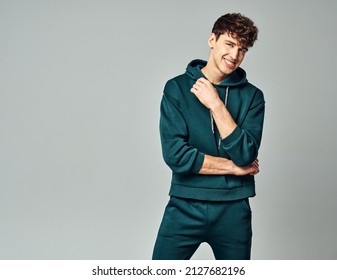Handsome man wear of green set of track suit isolated on grayl background