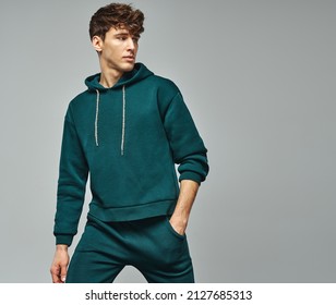 Handsome man wear of green set of track suit isolated on grayl background - Powered by Shutterstock