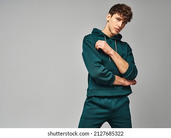 Handsome man wear of green set of track suit isolated on grayl background - Shutterstock ID 2127685322
