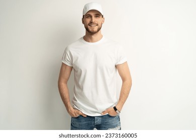 Handsome man wearing blank white cap and white t-shirt isolated on white background