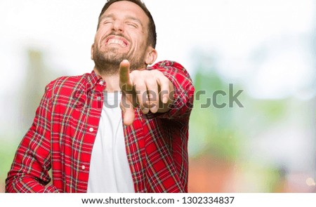 Handsome man wearing casual shirt Laughing of you, pointing to the camera with finger hand over chest, shame expression
