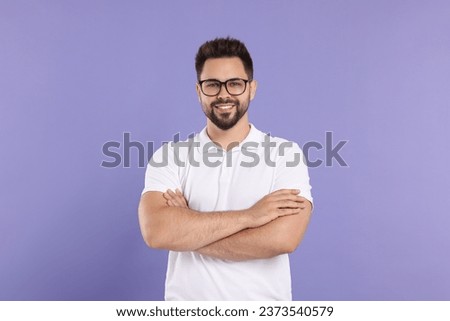 Handsome man wearing glasses on violet background Foto d'archivio © 