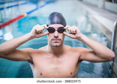 Handsome Man Wearing Swim Cap And Goggles At The Pool