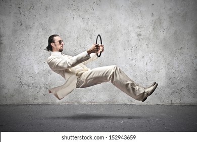 Handsome Man With White Dress Driving An Imaginary Car