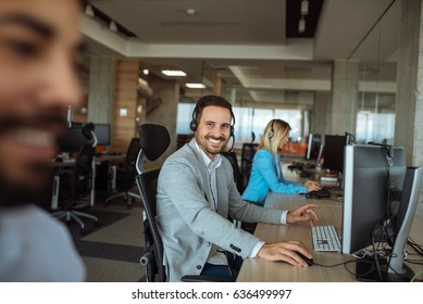 Handsome Man Working In A Call Center Office.