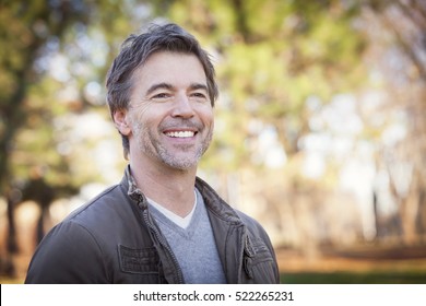 Handsome Mature Happy Man Smiling And Looking Away.Outside.
