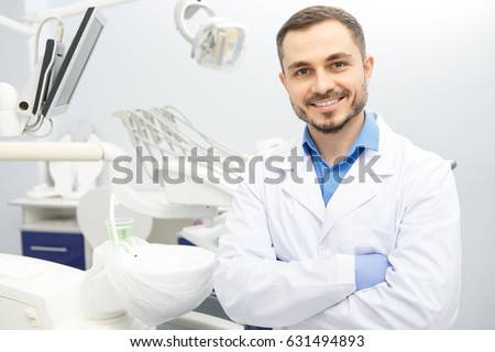 Handsome mature male dentist standing at his clinic smiling to the camera with his arms crossed copyspace profession dentistry experience medicine doctor occupation healthcare people concept
