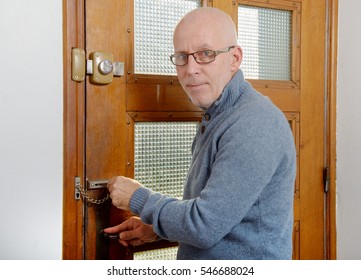 Handsome Mature Man With Blue Pullover Close The Door