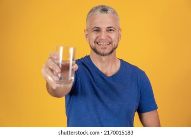 A Handsome Mature Man Holding A Glass Of Water. Older Man Drinking Water