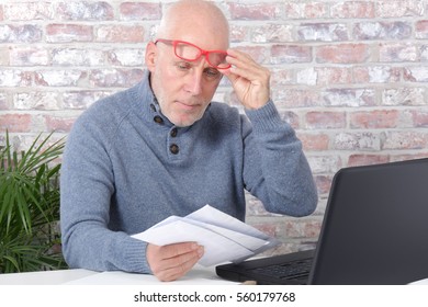 Handsome Mature Man Opening Letter Envelope In His Office