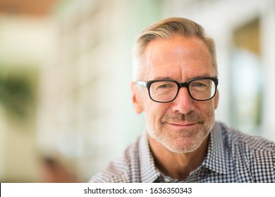 Handsome mature man smiling looking at the camera.